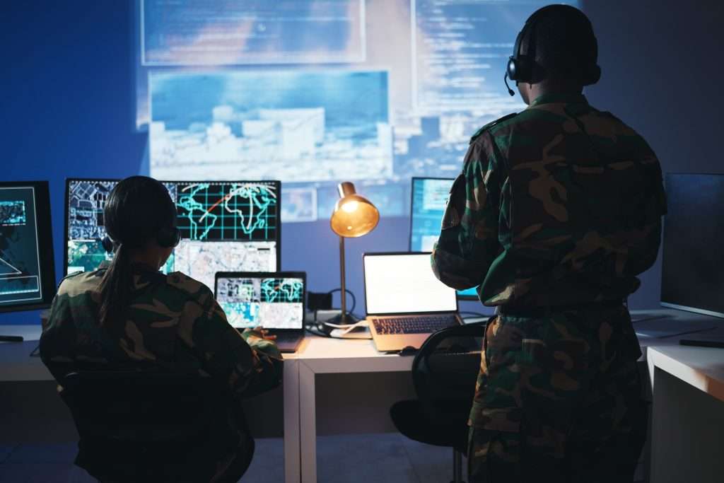 Control room, military and people on computer for surveillance, tracking operation and national sec